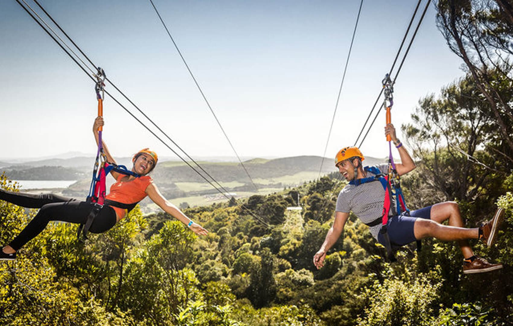 Guest zip lining over the forest canopy above the Kelani River, Kithulgala