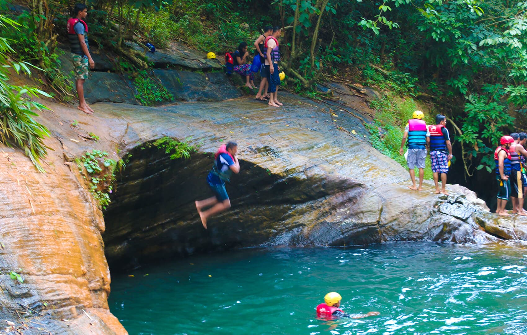 Guide cliff-jumping into a waterfall pool, Makandawa Reserve, Kithulgala