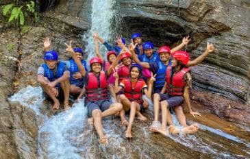 Guests celebrating at a waterfall after a canyoning adventure, Kithulgala