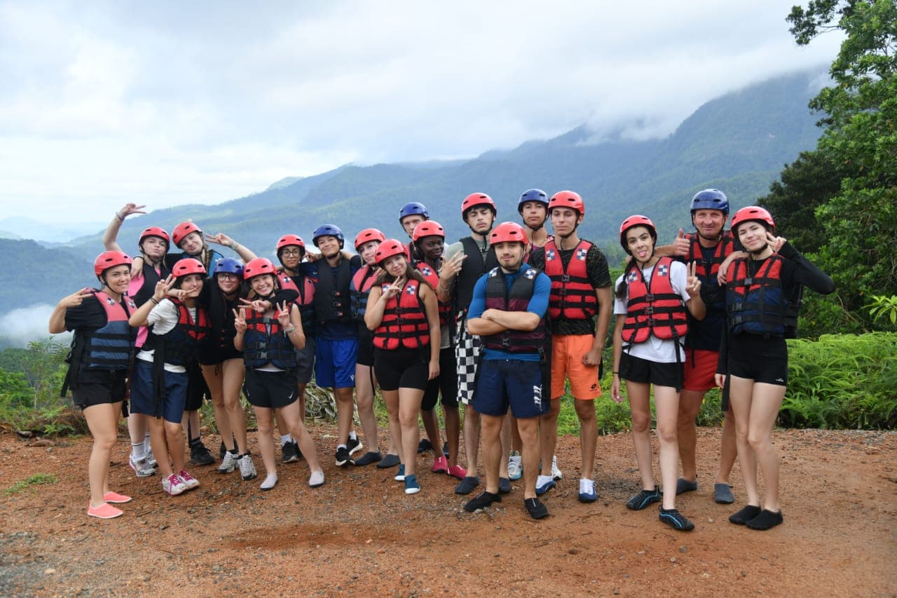 Adventure group celebrating after white water rafting run