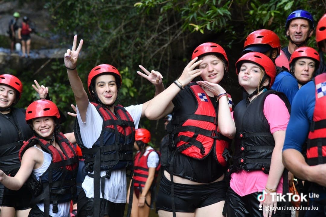 Rafting group posing together in full safety gear