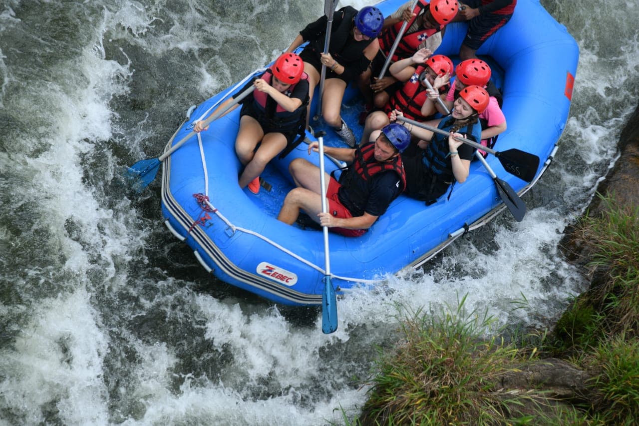 Rafters splashing through the final rapid drop in Kithulgala